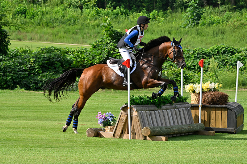 Marissa jumping her horse cross country