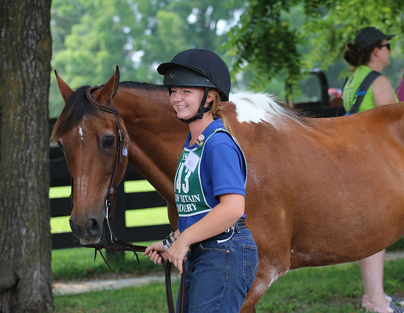 Smiling girl with her horse