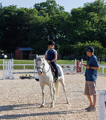 A girl and her pony in a lesson with Boyd Martin.