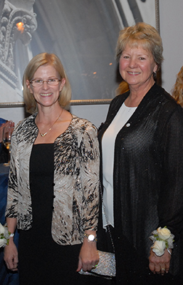 Two women facing the camera, smiling.