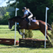 A girl jumping Cross-Country with her horse.