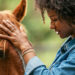 woman petting horse