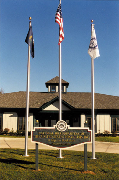 building with flags and sign