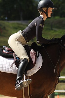 Teagan demonstrates a correct two-point position in hunt seat equitation.