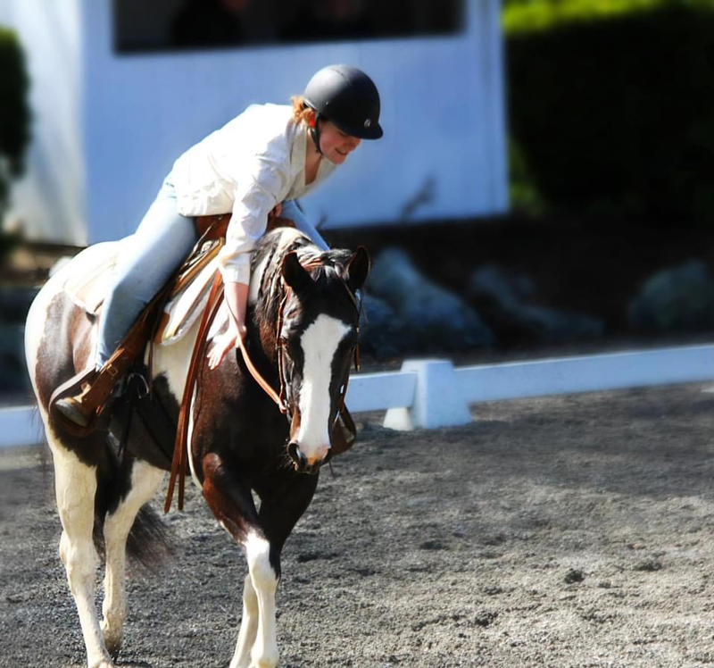 Charlotte Tincher rides her horse.