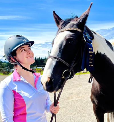 Charlotte Tincher with her horse for a blog where she discusses how Pony Club kickstarted her career
