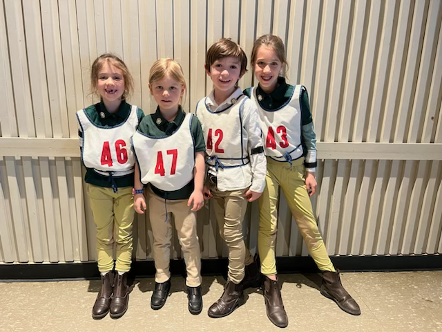 A group of young kids smiling at the camera.