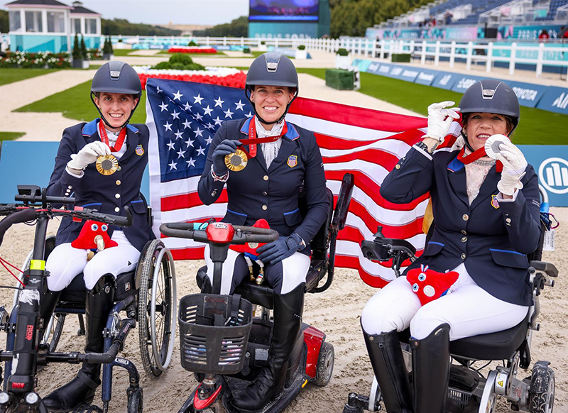 Three paralympic dressage athletes on the medal podium.