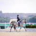 A paralympic dressage athlete competing on her horse.