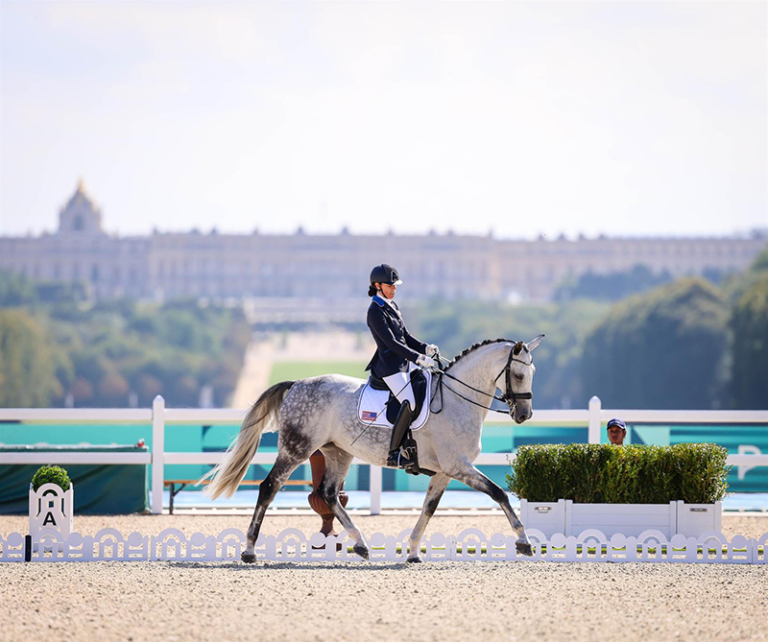 A paralympic dressage athlete competing on her horse.