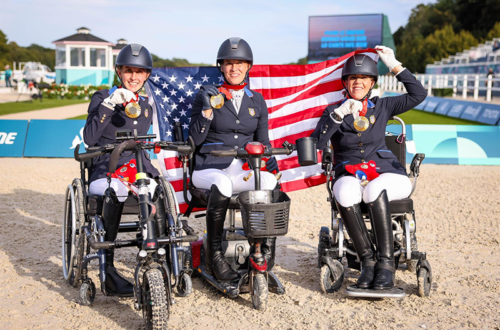 Three paralympic dressage athletes on the medal podium.