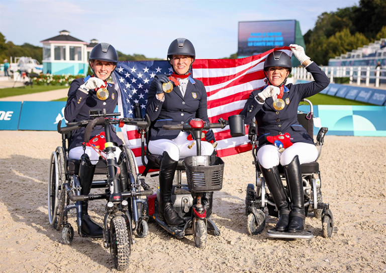 Three paralympic dressage athletes on the medal podium.