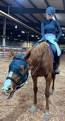 A young girl sitting on her horse.