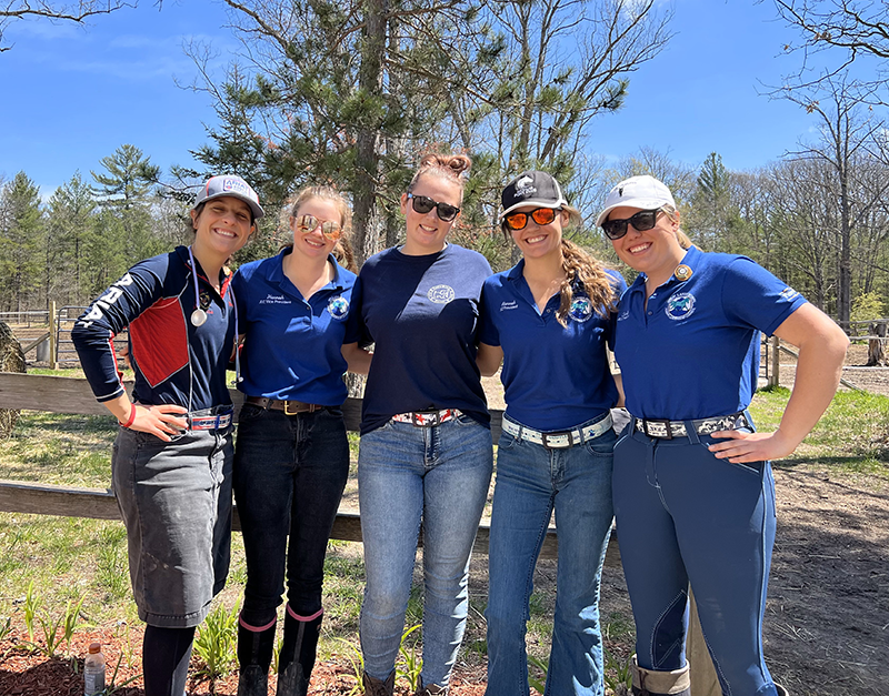 A group of young women smiling at the camera.