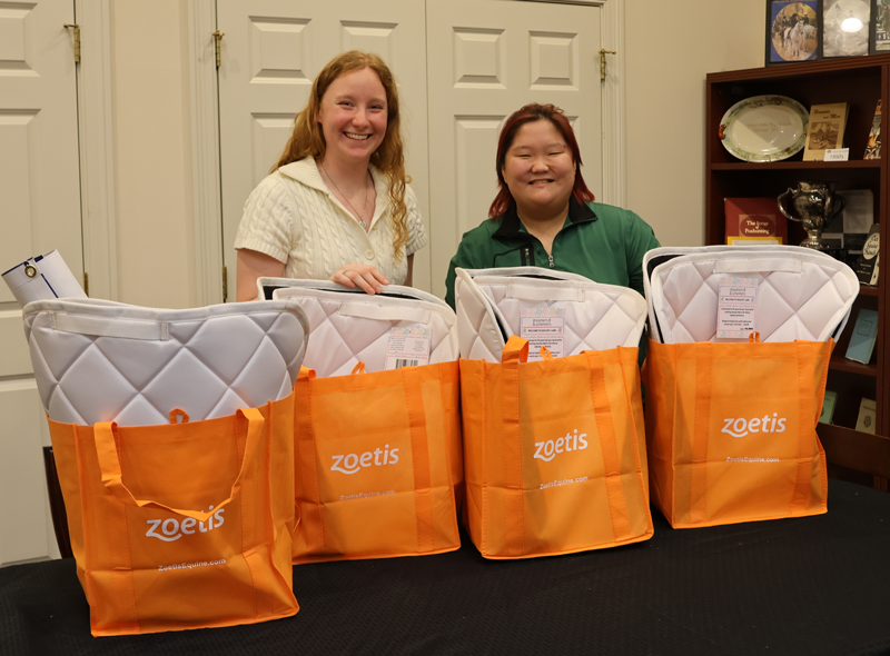 Loralye Page (left) and Sage Argent (right) work on swag bags for the USPC team for the 2025 USEF Pony Jumper Championships at USEF Pony Finals. Liz Moyer/United States Pony Clubs