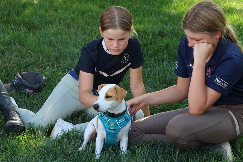 Emma Shade Kleintop and Molly Myers with Richard Lamb's dog. Elizabeth Moyer/United States Pony Clubs