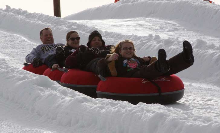 A family tubing in the snow.