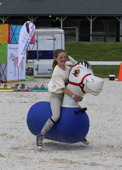 Enjoying the bouncing ponies at the Kentucky Kids Club.