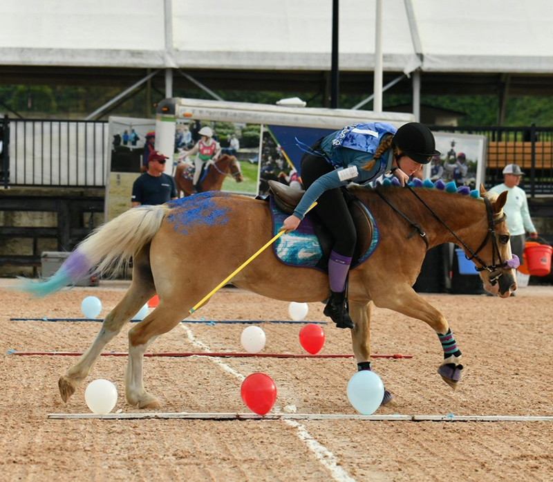 A young woman riding her horse in Mounted Games.