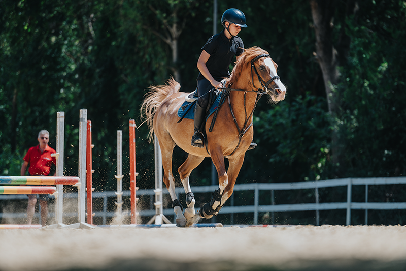 A young person riding a horse.