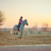 A woman riding a horse in an arena.