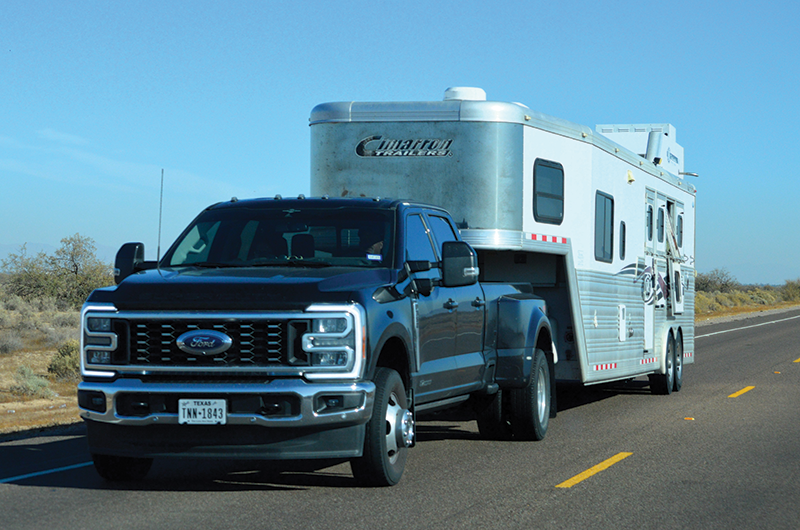 A truck pulling a horse trailer.